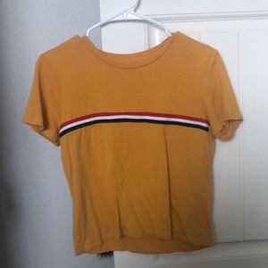 yellow shirt with red,black,and white strips